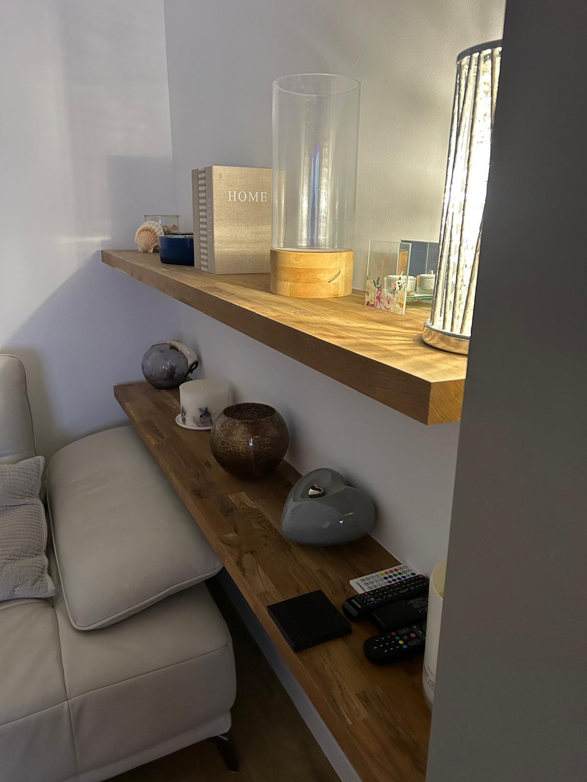 Bespoke floating shelves installed and styled in a living room